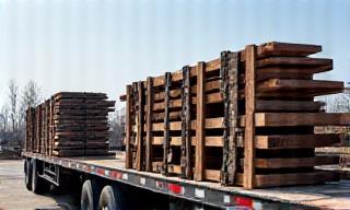 Flatbed truck hauling heavy equipment